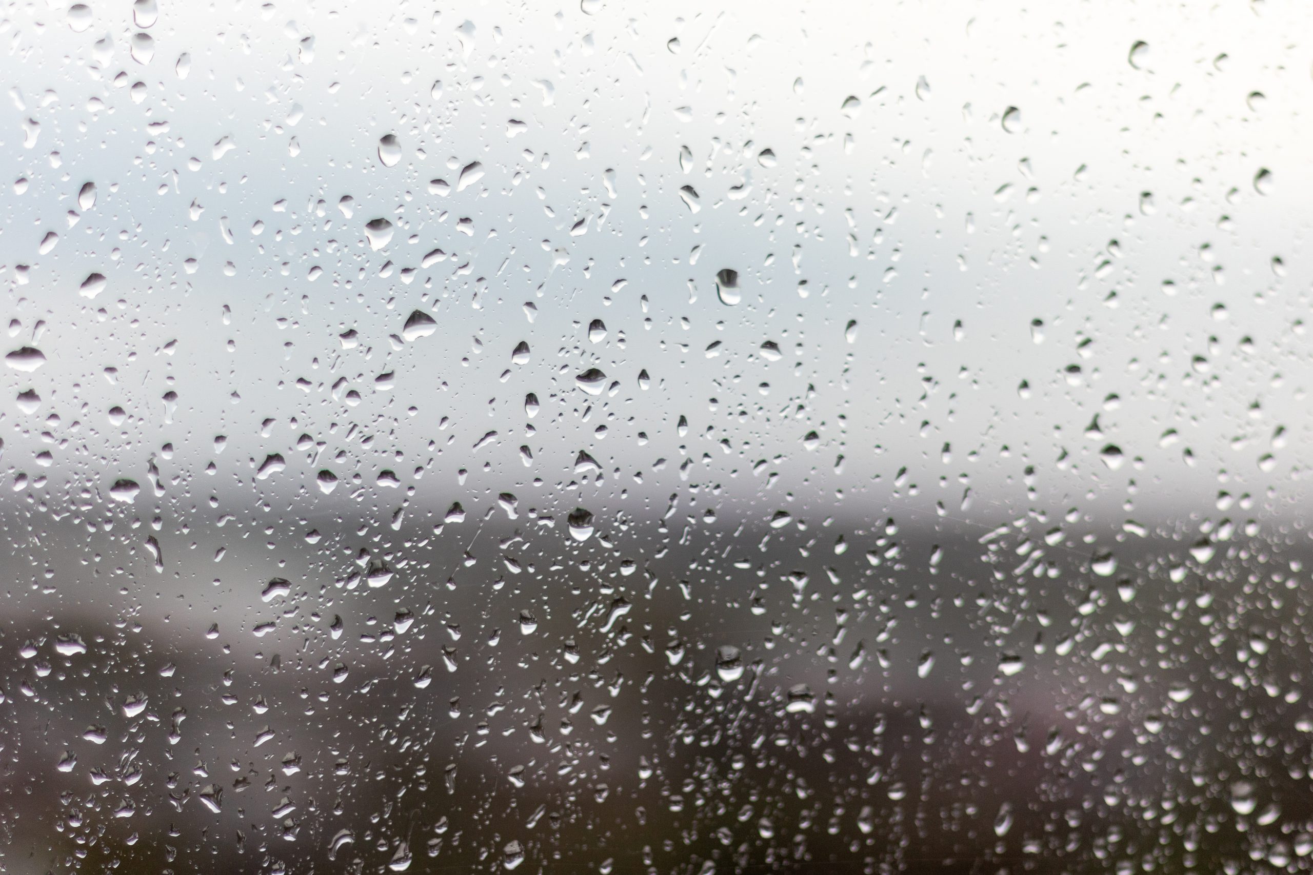 closeup-shot-of-a-window-on-a-rainy-day-raindrops-rolling-down-the-window