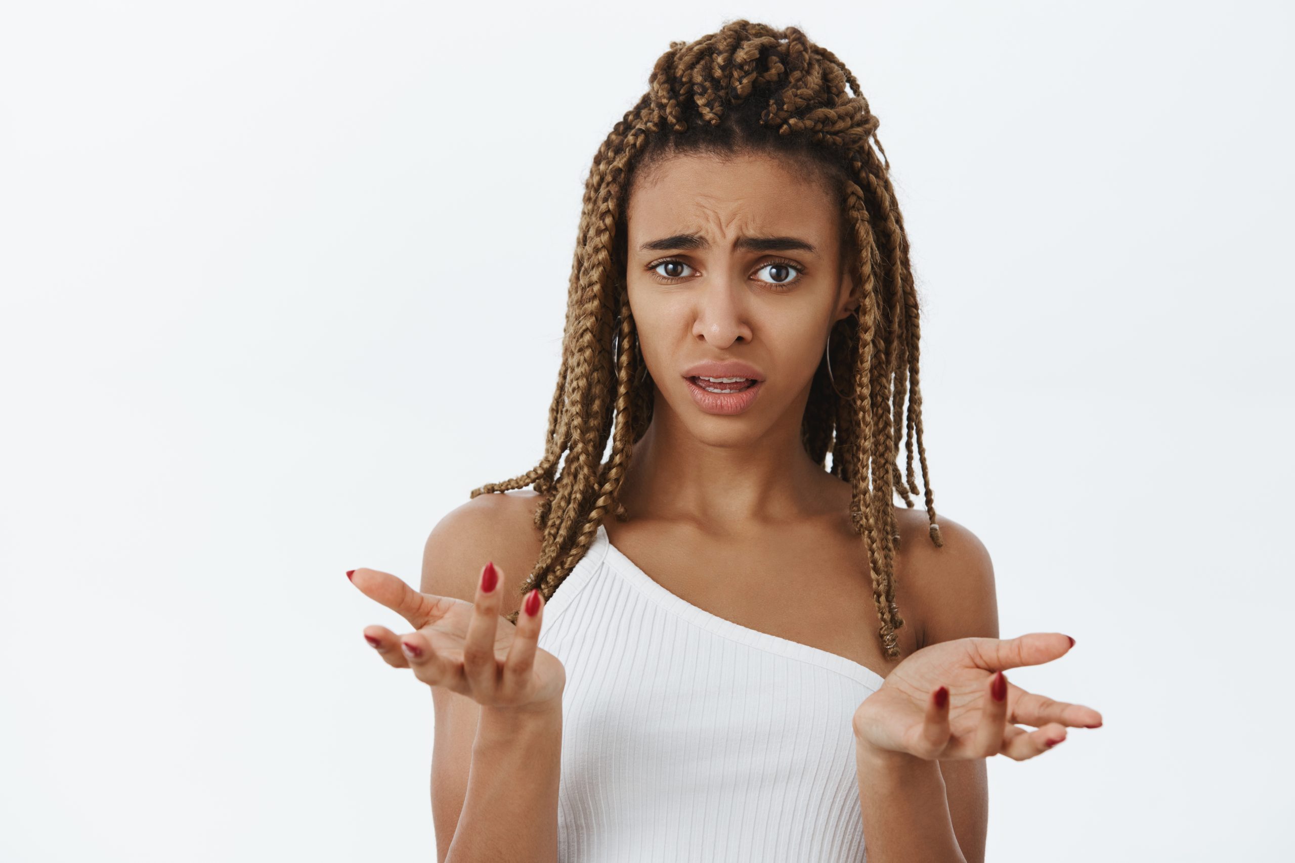woman-feeling-confused-cannot-understand-what-friend-hinting-at-portrait-of-clueless-and-questioned-unaware-dark-skinned-female-with-dreads-feeling-intense-shrugging-with-raised-arms-and-frowning