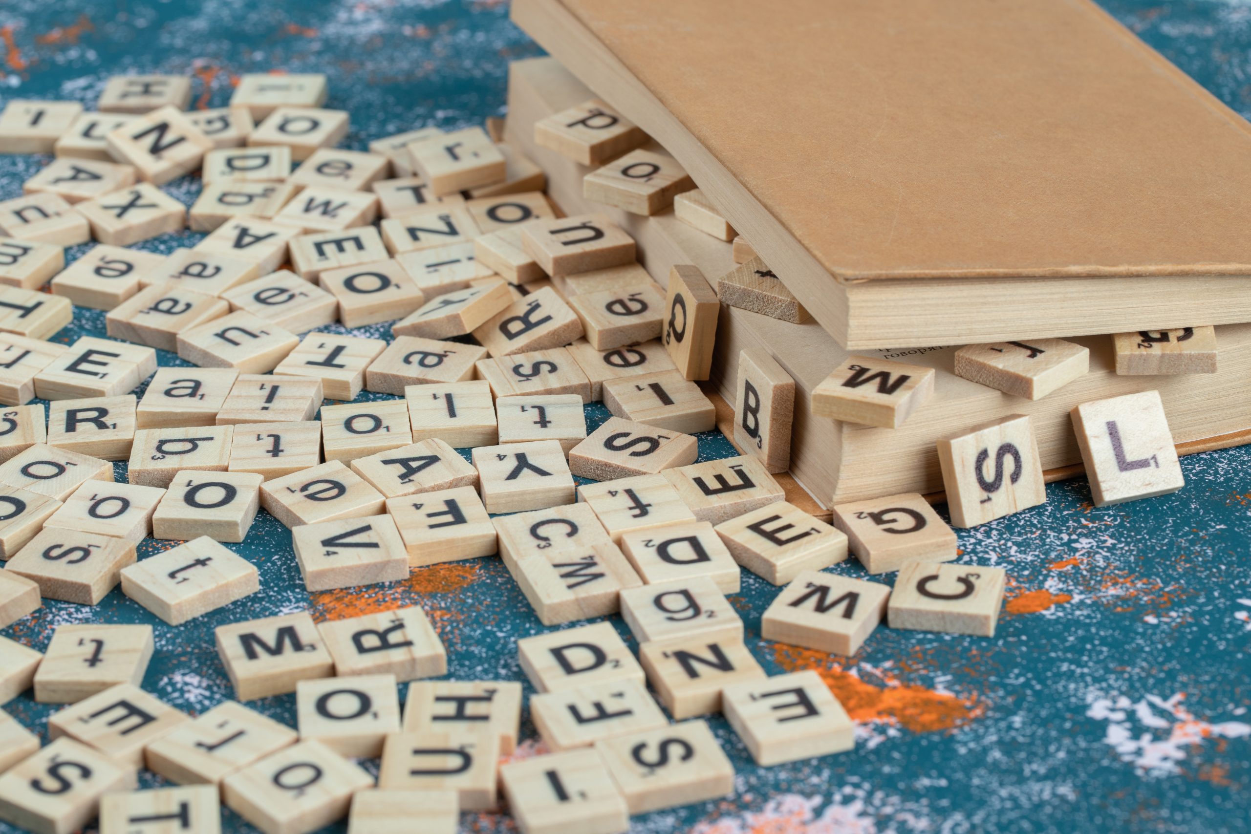 wooden-dice-with-letters-on-them-between-the-pages-of-a-book