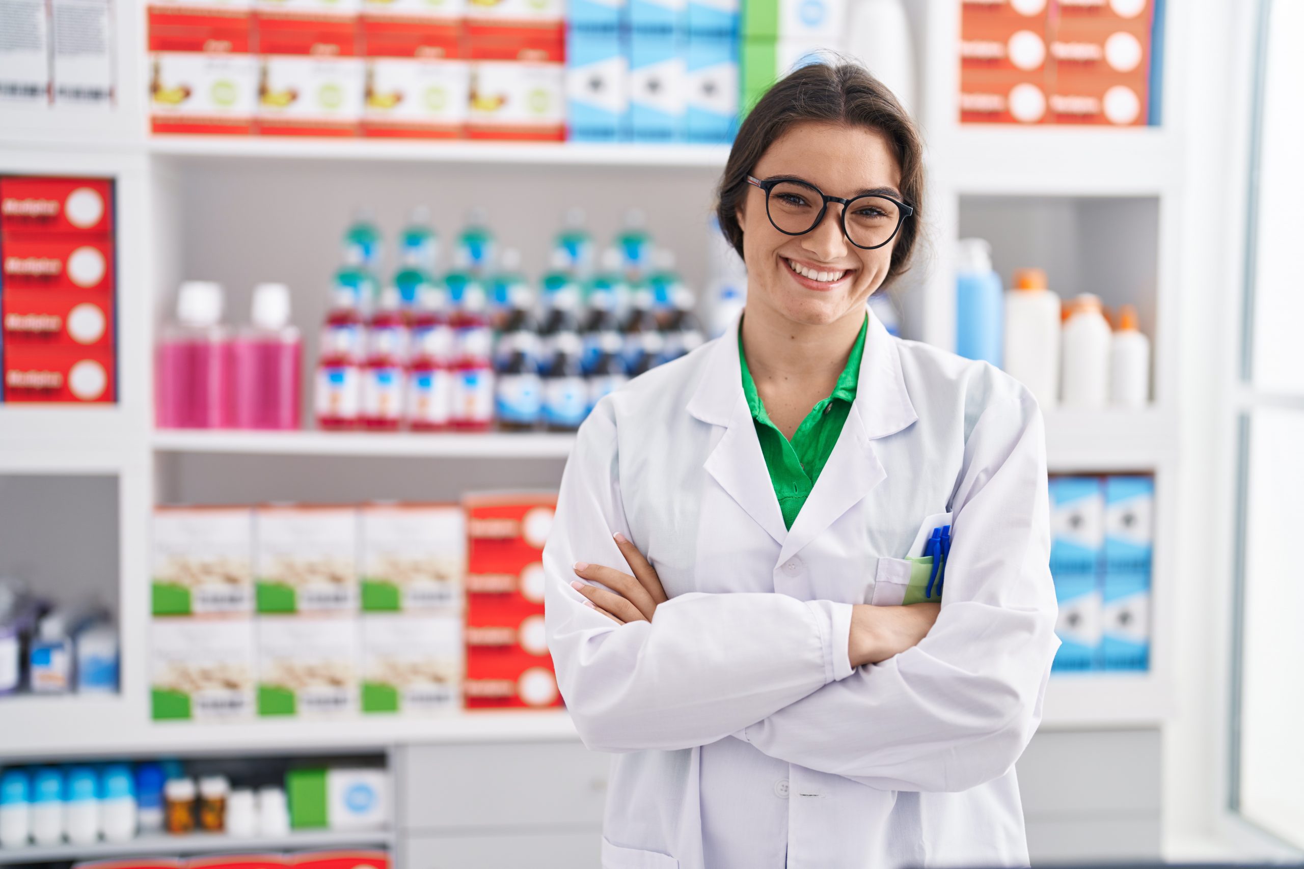 young-hispanic-woman-pharmacist-smiling-confident-standing-with-arms-crossed-gesture-at-pharmacy